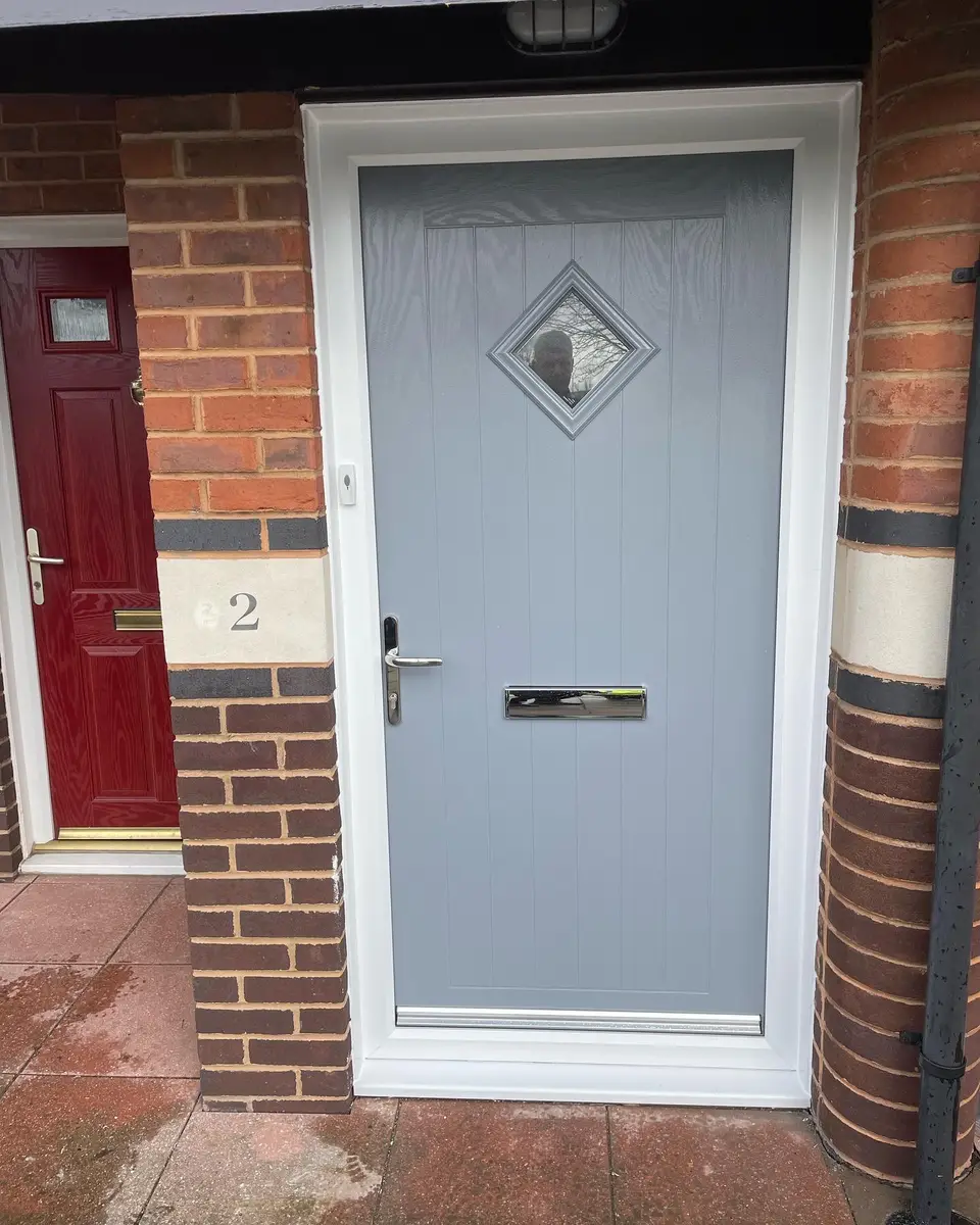 Grey composite front door in Newcastle Light grey composite front door with a diamond glass panel on a home in Newcastle upon Tyne