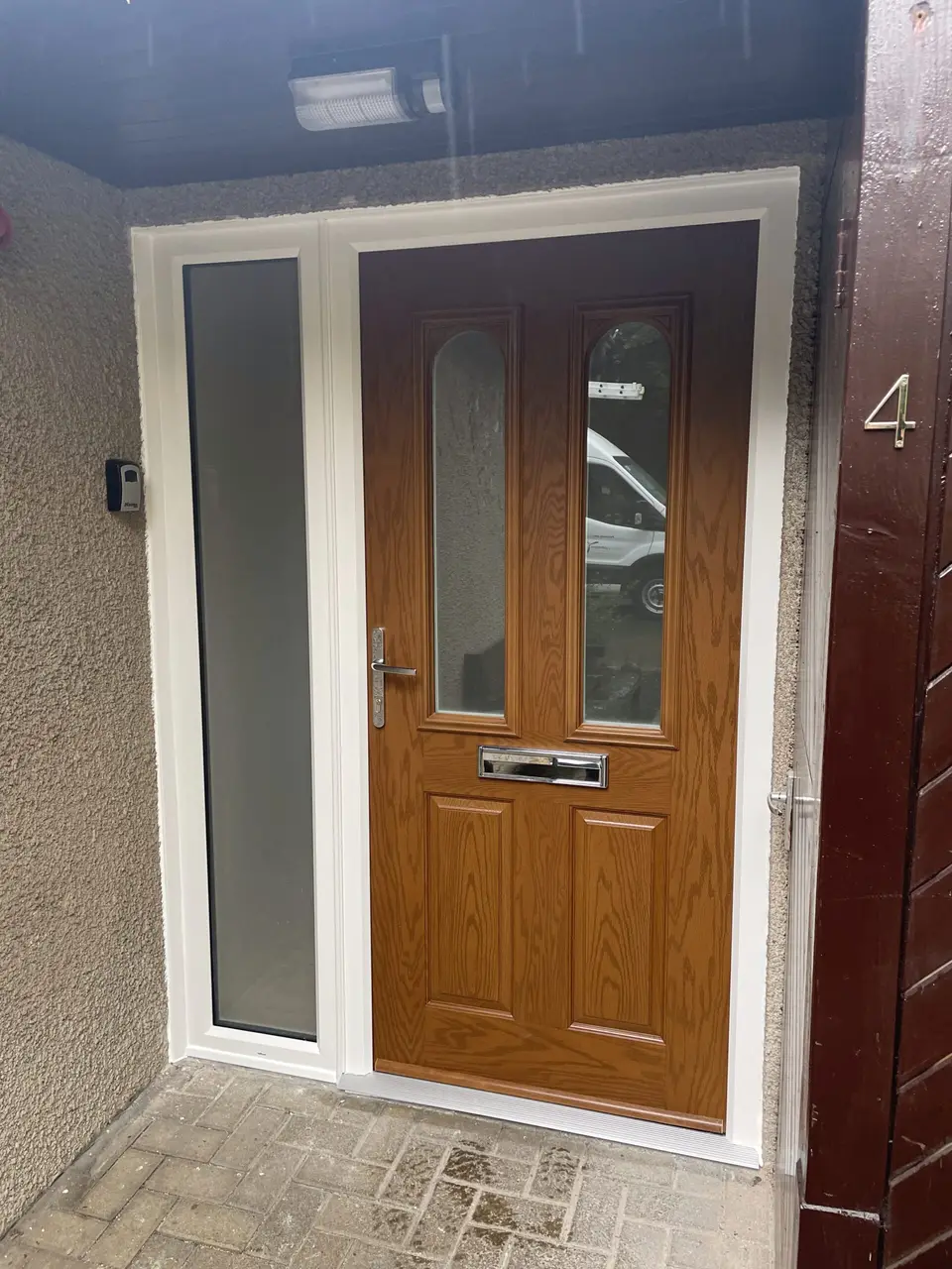 Oak-effect composite door with side panel, Newcastle Oak-effect composite front door with an obscure glass side panel at a Newcastle property