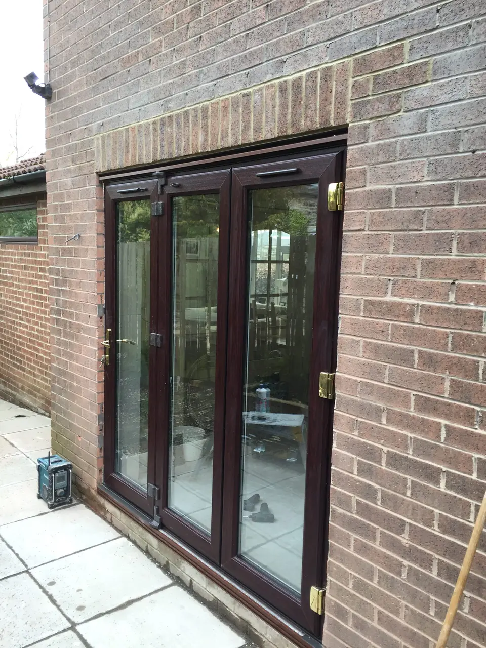 Rosewood-finish uPVC bi-fold doors fitted in a brick extension in Newcastle upon Tyne